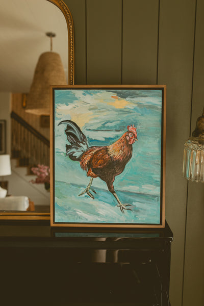 Original oil painting of a strutting rooster on a sea-glass blue background by Chantry Brewer, in a natural wood floater frame