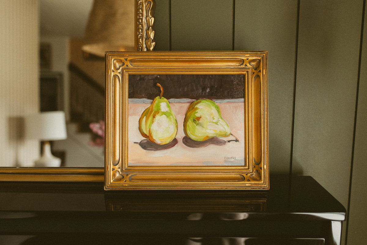 Original oil still life of two green pears against a deep plum background by Chantry Brewer, in a carved gold frame