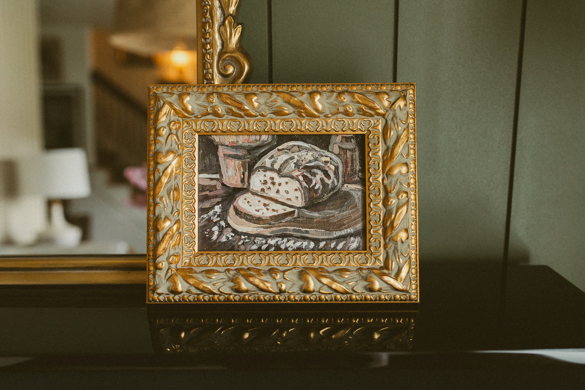 Original oil still life of a sliced rustic loaf on a wooden board by Chantry Brewer, in an ornate gold and cream frame