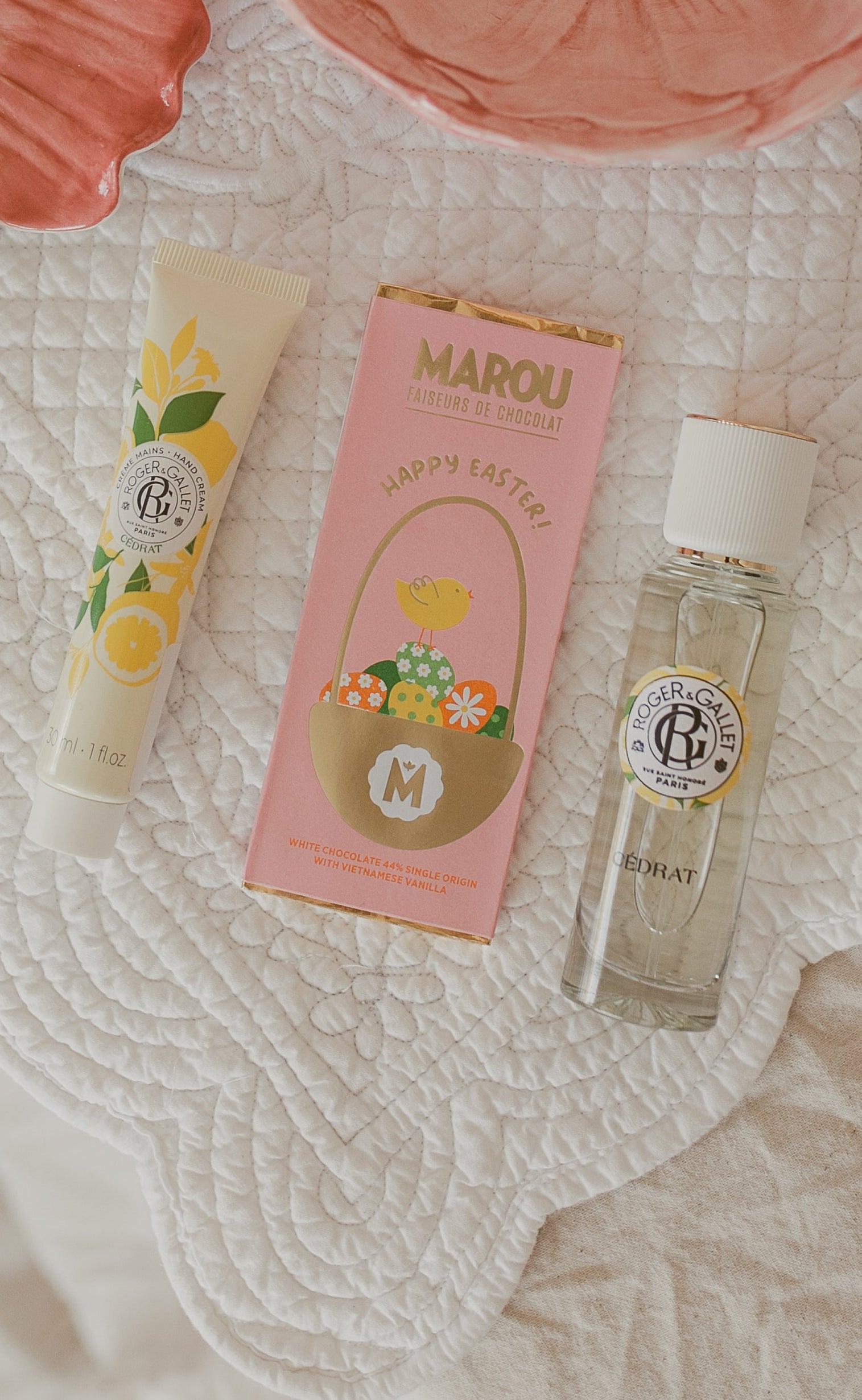 Two pink ceramic bowls with decorative elements on a textured surface.